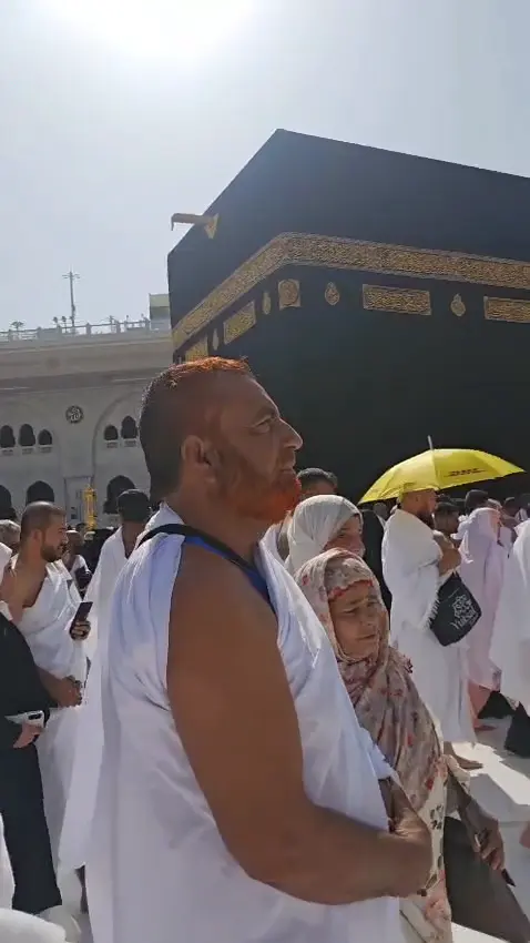 A pilgrim from the group near the Kaaba at Masjid al-Haram